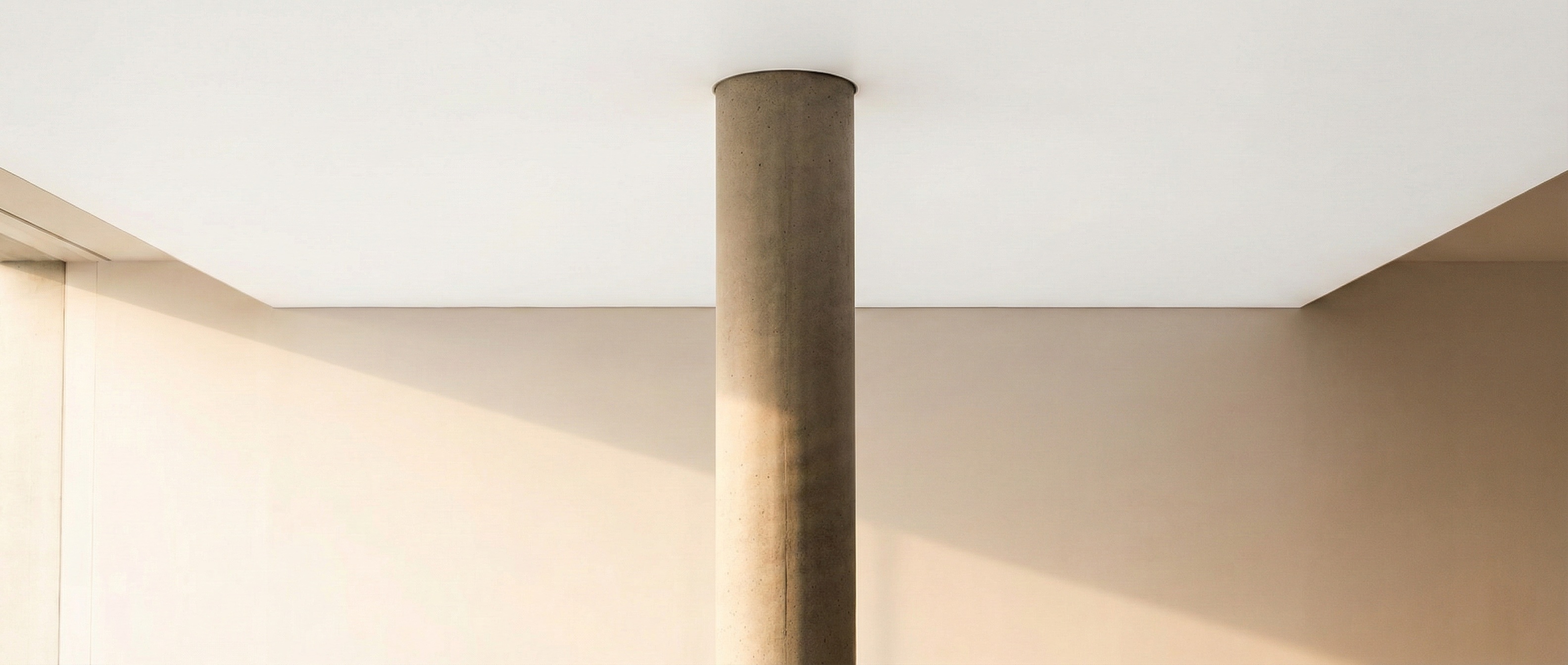 Single concrete pillar supporting a vast clean ceiling, monolithic, structural, powerful